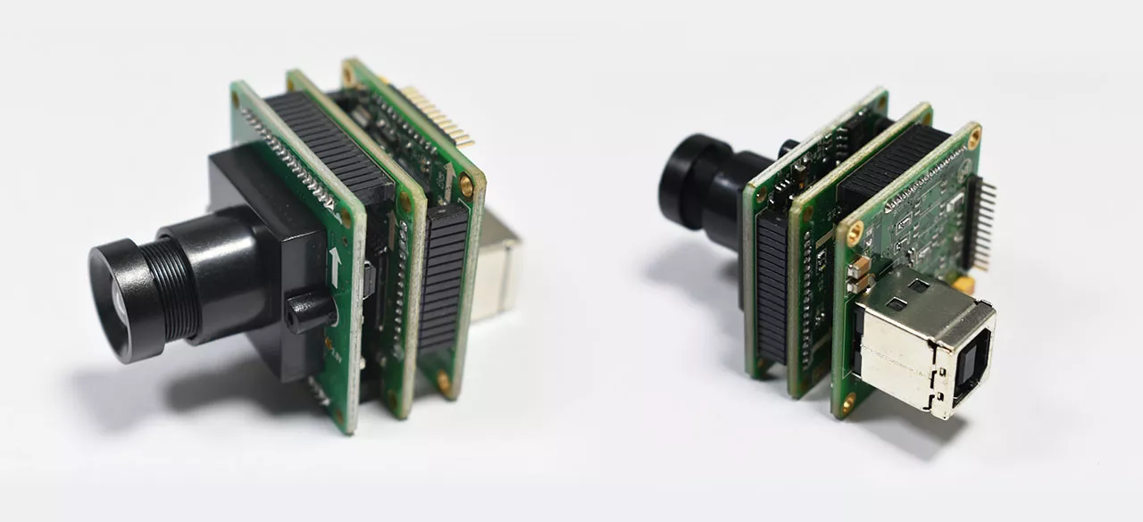 These are two industrial grade camera modules, essential components in the field of machine vision and industrial inspection. Composed of circuit boards, lenses, and interfaces, they showcase a compact and practical design typical of industrial equipment.

The green circuit boards are integrated with various electronic components, enabling signal processing and data transmission. The black lenses, crucial for image acquisition, are designed to capture high quality visual information. On one side, different data interfaces (such as USB like interfaces) are present, facilitating seamless data transfer between the camera modules and external systems.

Widely applied in scenarios like machine vision systems, industrial inspection processes, and automated quality control, these camera modules play a vital role in capturing images and transmitting data accurately. For those interested in industrial camera technology, machine vision solutions, or industrial inspection equipment, these modules represent core components that drive efficiency and precision in industrial operations. Whether you're researching "industrial camera modules for machine vision", "high precision industrial inspection cameras", or "USB interfaced industrial camera designs", these devices fit the bill for enhancing visual data acquisition in industrial settings.